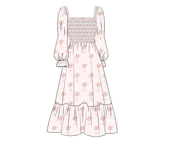 A flat line-art illustration of a long-sleeve dress with a smocked bodice and a tiered skirt, shown on a plain white background. The dress is light pink with a small floral print and a gray-and-white patterned smocked section.