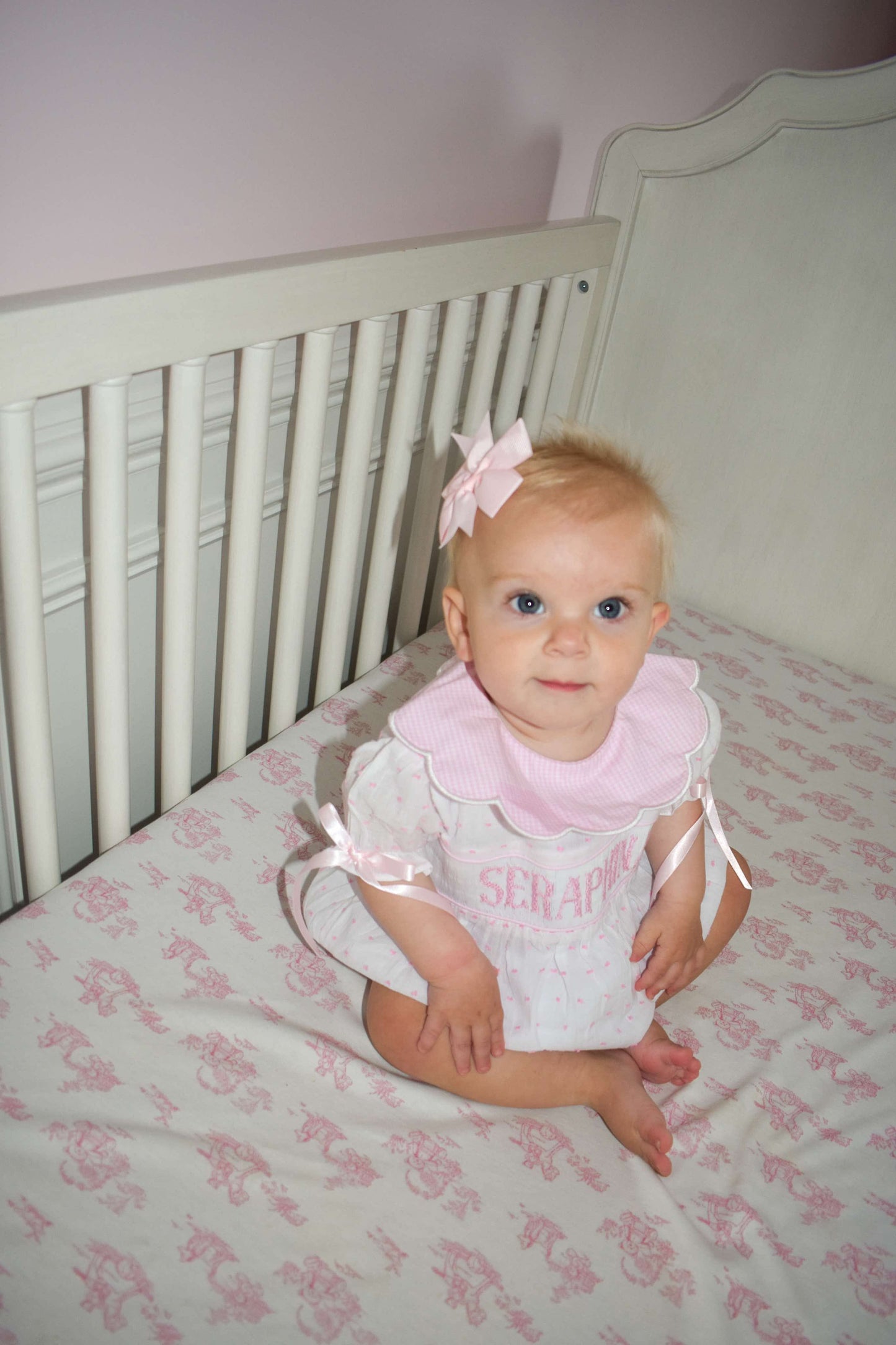 Heirloom pink name smocked Swiss dot bubble in 100% cotton for babies and special occasions