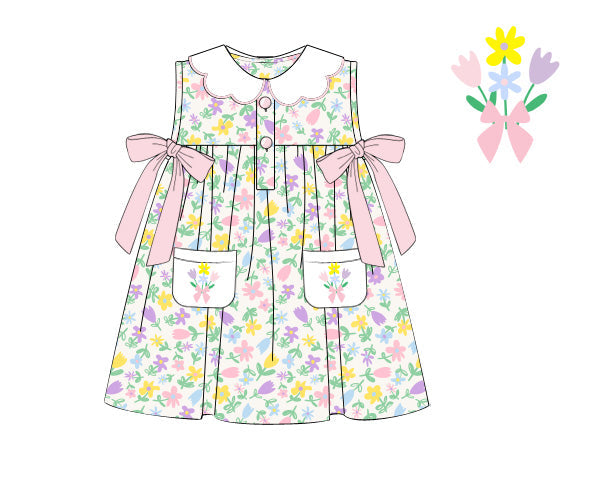 Children's floral dress with pink bows on a white background