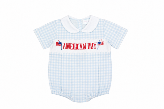 Baby romper with 'American Boy' text and checkered pattern on a white background