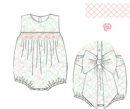 Sewing pattern for a baby romper with floral design on a white background