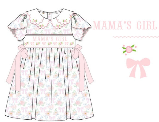 Hand-smocked MAMA’S GIRL dress in 100% cotton with flowers, bow, hand-embroidered rosettes, scalloped collar and sleeves. Classic, timeless, heirloom design.