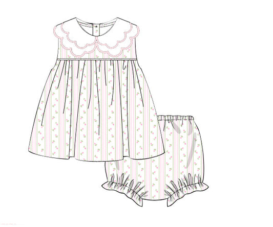 Line drawing of a children's dress and bloomers with floral patterns on a white background.