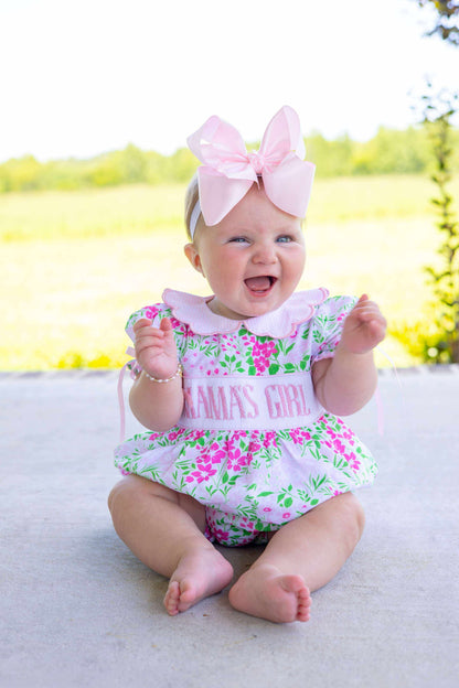 100% cotton Floral Mama’s Girl Petal Pop Bubble with hand-smocked MAMA’S GIRL, flowers, bow, and petal-inspired skirt. Classic heirloom design.