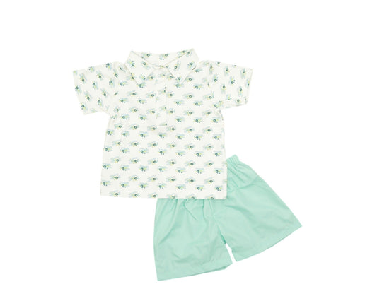 Children's outfit with a patterned shirt and green shorts on a white background