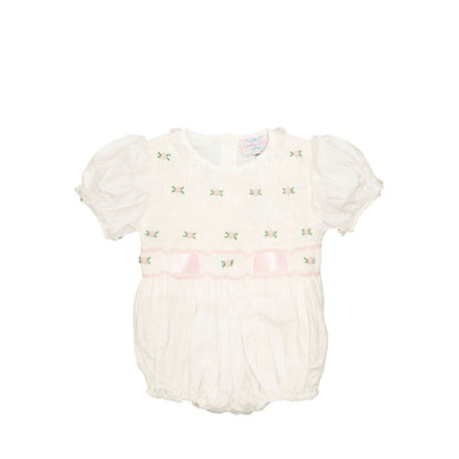 White baby romper with floral details on a white background