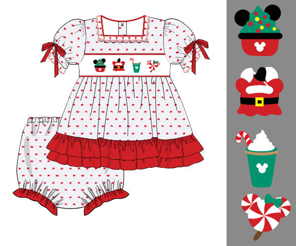 A children's dress and matching bloomers shown as a flat product illustration on a white background, with a vertical strip of holiday-themed character/food icons on the right. The dress is white with small red polka dots, red ruffled trim, red bow sleeves, and a white yoke with red embroidered-style motifs.
