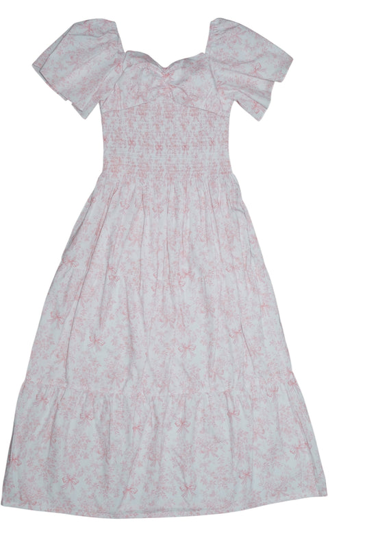 White dress with pink floral pattern on a white background