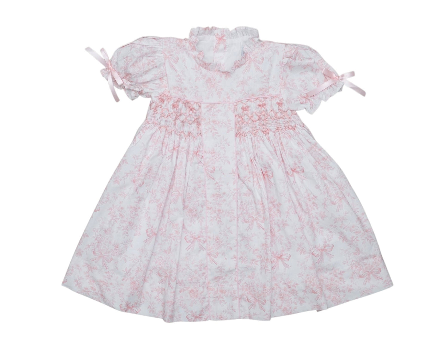 White dress with pink floral pattern on a white background