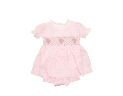 Pink baby romper with floral details on a white background