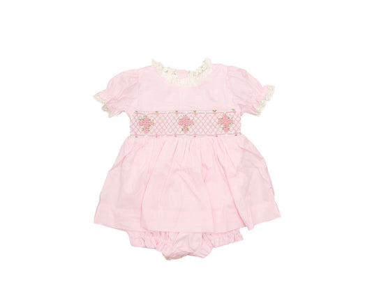 Pink baby romper with floral details on a white background