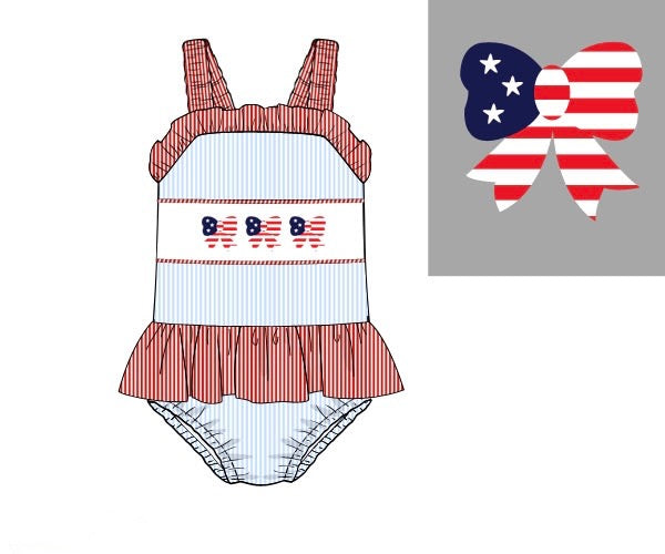 Girls Stars & Stripes bathing suit with hand-smocked flag details and snaps for sizes 3M–3T. Classic patriotic swimwear for summer.