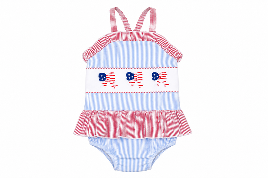Children's swimsuit with red, white, and blue design on a white background