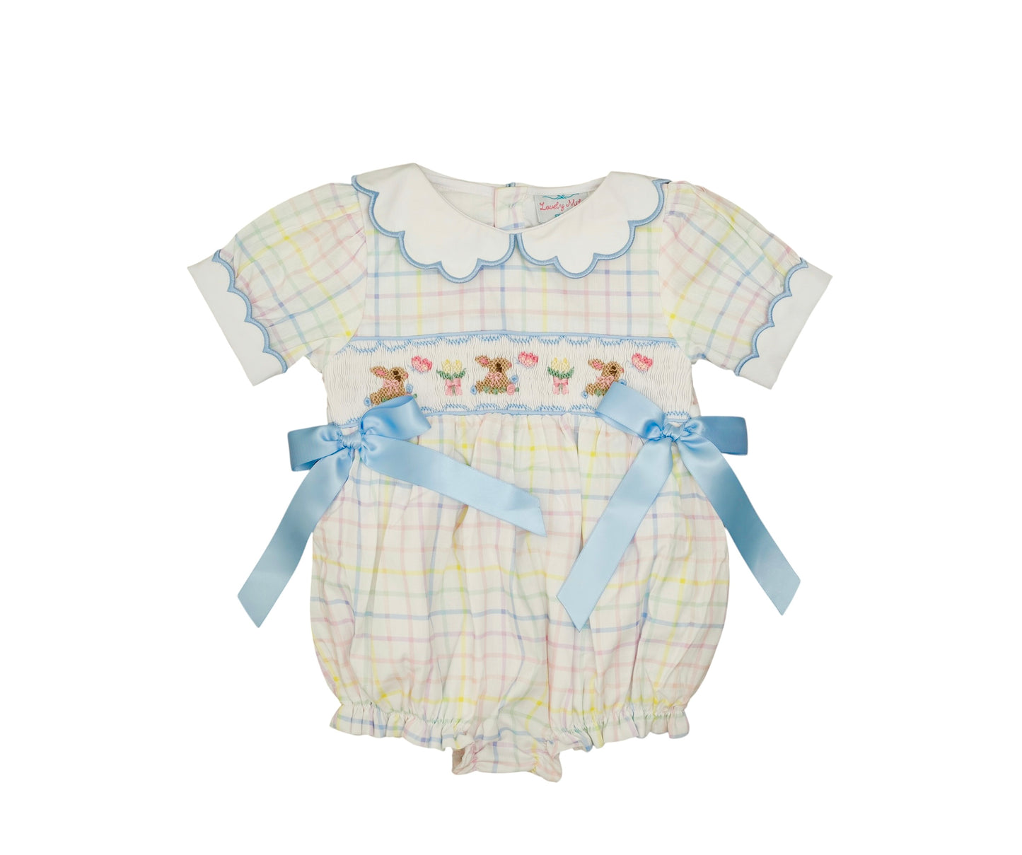 Baby romper with checkered pattern and embroidered details on a white background