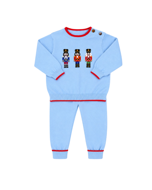 Light blue children's pajama set with red trim on a white background