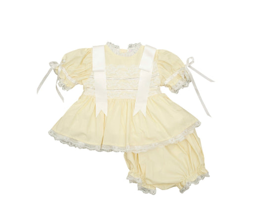 Yellow dress with white accents on a white background