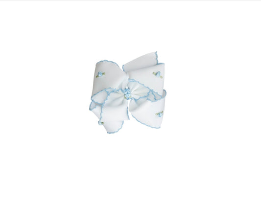 White hair bow with blue accents on a white background