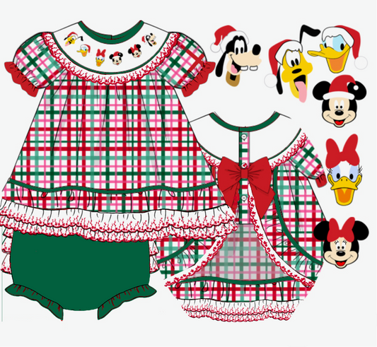 A flat lay product graphic showing two children's holiday-themed dresses with red and green plaid patterns, ruffles, and character faces on the neck, alongside five cartoon character illustrations wearing Santa hats. Text at the bottom reads '2026 0702XK' and 'custom woven'.