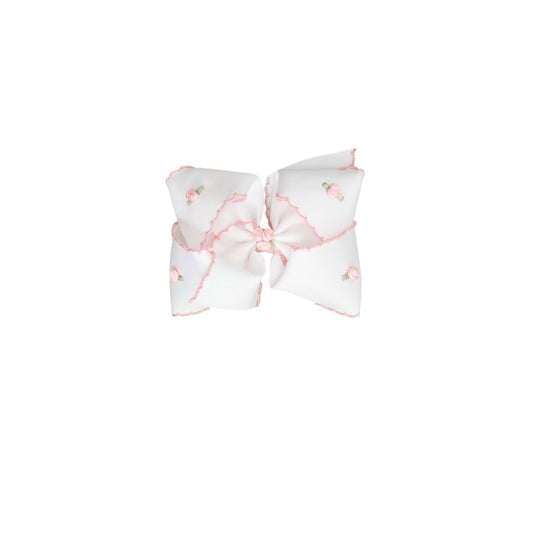 Hair bow with pink and white pattern on a white background